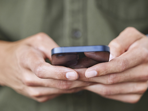Closeup shot of an unrecognisable man using a cellphone