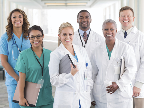 Large diverse group of hospital doctors, surgeons, and nurses